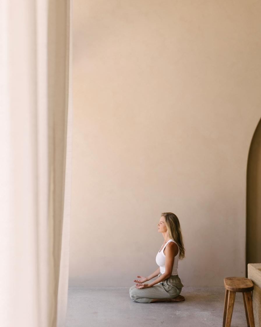 Elle kneeling, small in a wide and quiet room