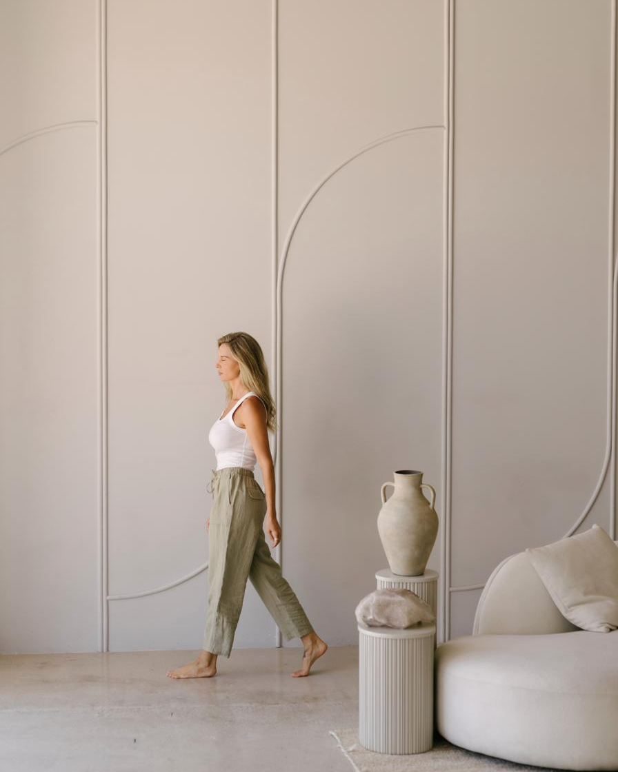 Elle walking through an archway in soft light