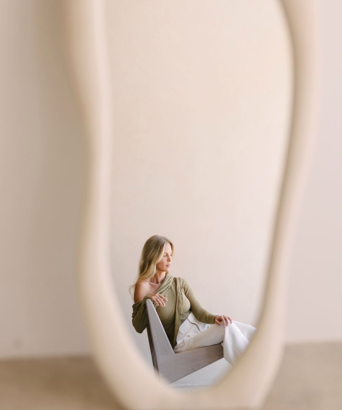 Elle reflected in a sculptural standing mirror